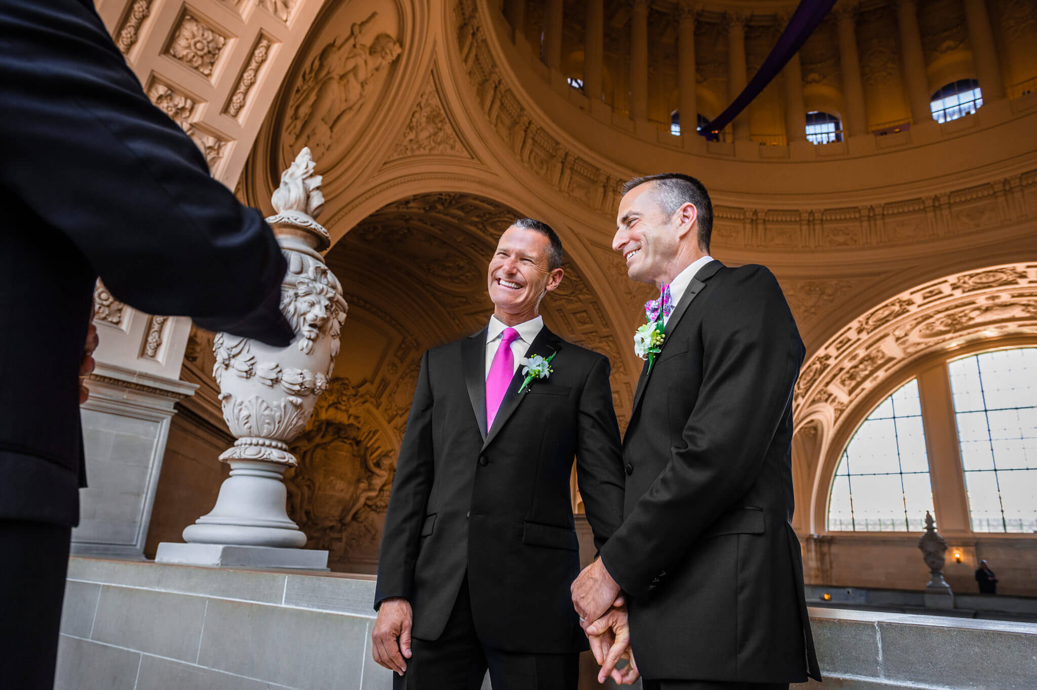 Two men laugh and hold hands as they are officially married at the San Francisco City Hall