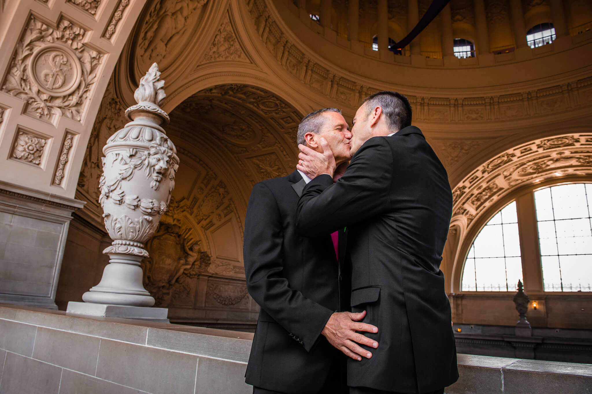 Grooms kiss at the altar at San Francisco City Hall after they become officially married