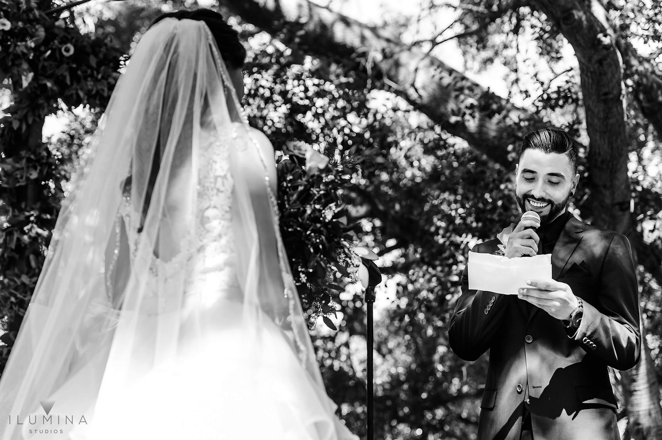 Black and white image of groom reading vows to bride at Anaheim Oak Canyon Nature Center wedding