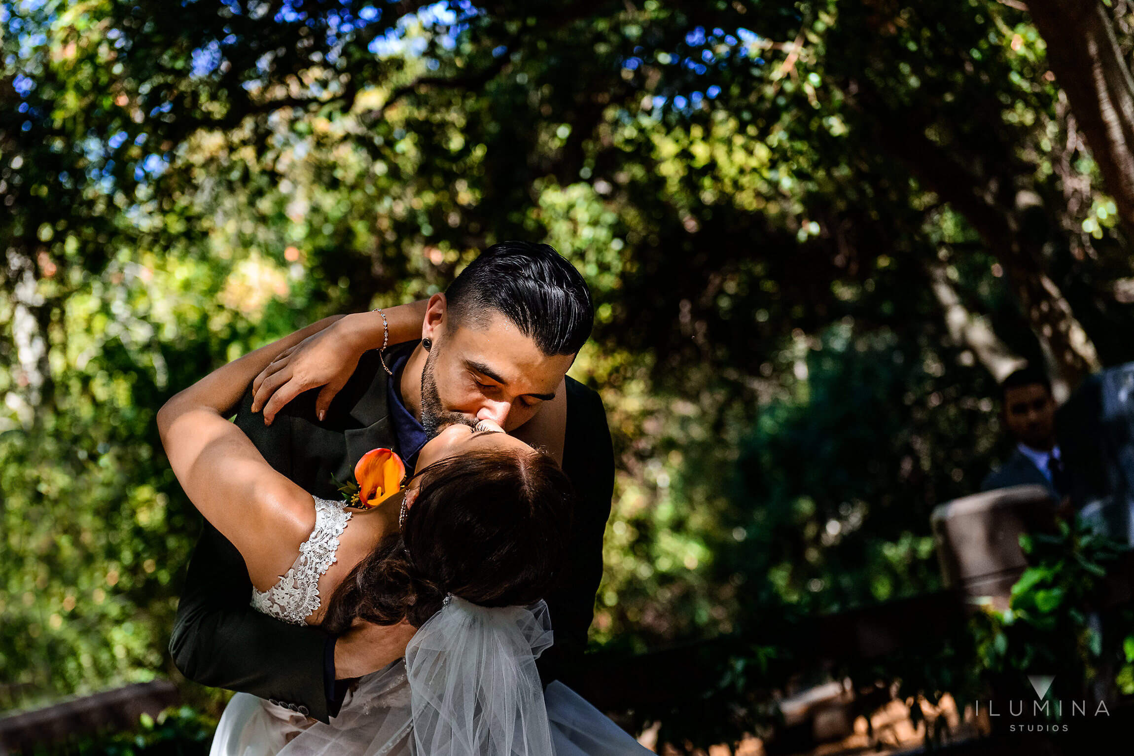 Color photo of groom dipping bride and giving her a kiss at Anaheim Oak Canyon Nature Center wedding