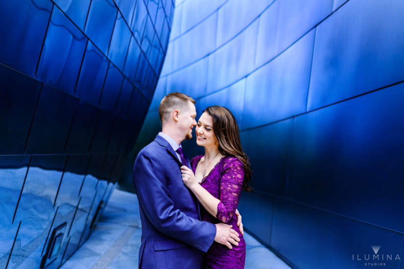 Color photo of man and woman smiling and hugging during engagement photoshoot at the Walt Disney Concert Hall in Los Angeles, California