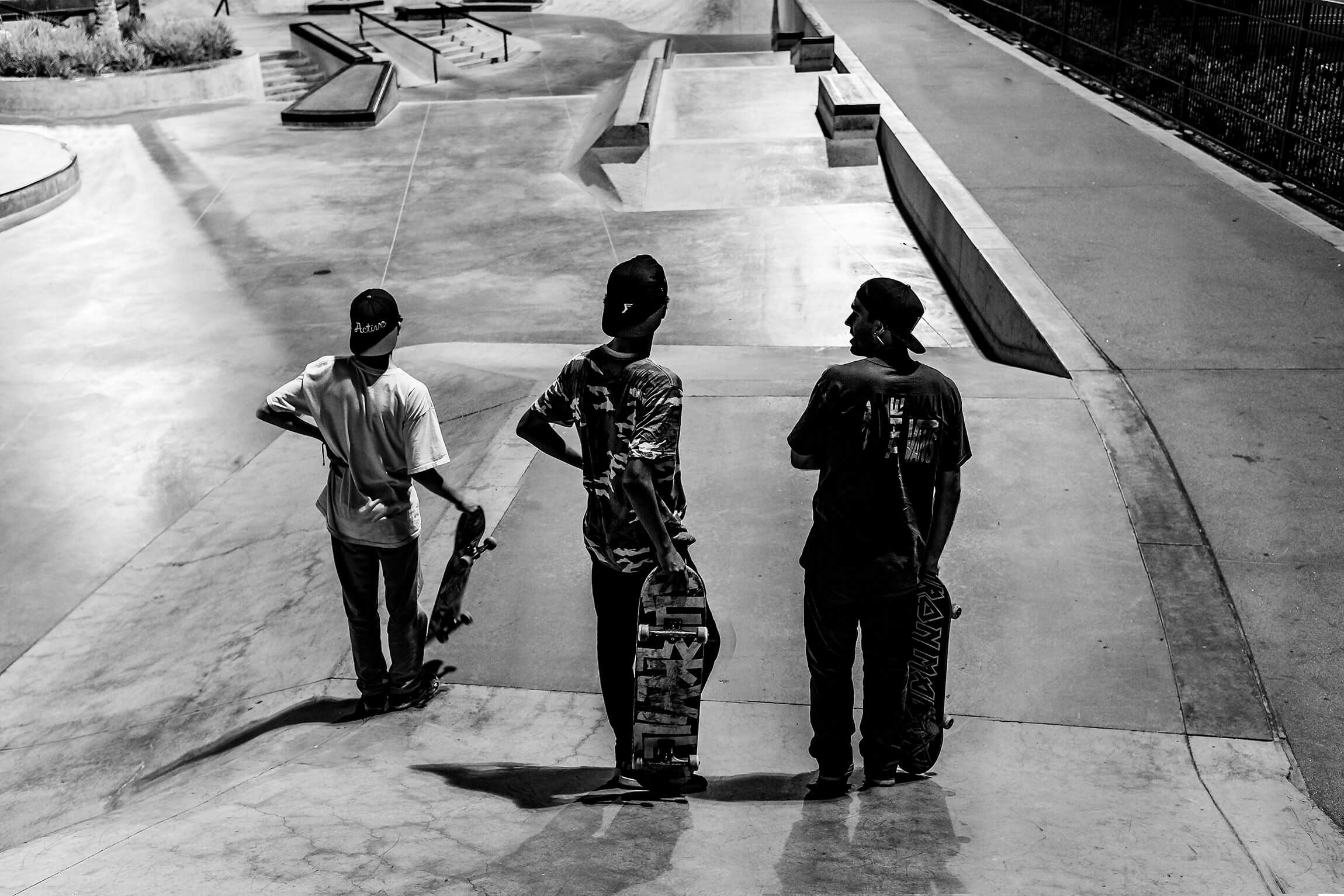 Silhouette of Skateboarders at Skatepark